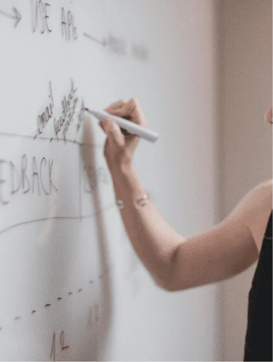 UX designer reviewing a digital product audit report on a laptop, analyzing user experience metrics and interface wireframes