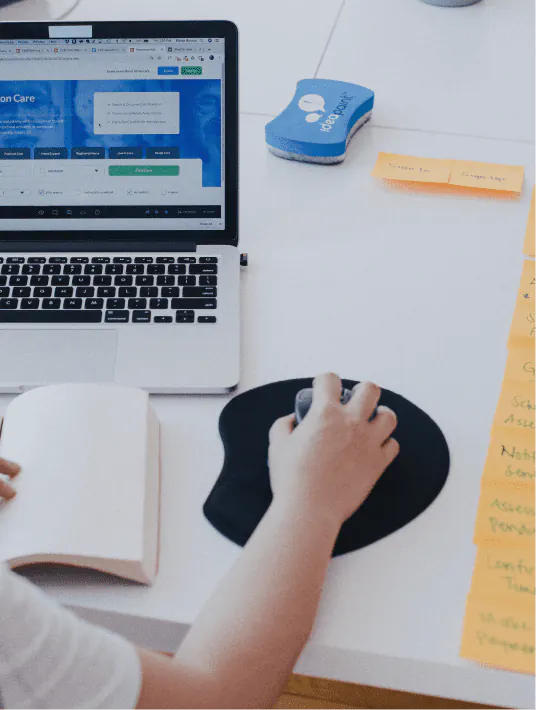 A UX researcher conducting a usability testing session, observing a participant interacting with a digital product on a screen to identify pain points and improve user experience.