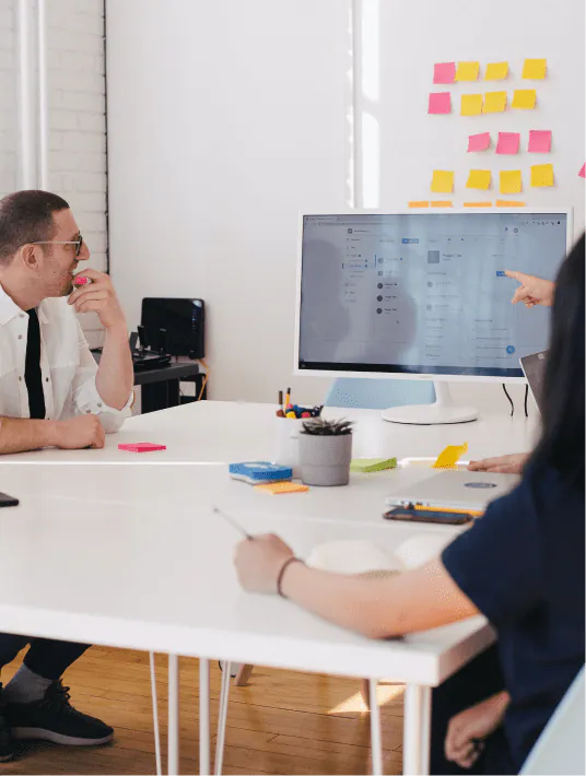 A UX consultant presenting research findings, usability audit results, and design system recommendations to a product team, representing the strategic role of UX consulting in driving business growth and product improvement.