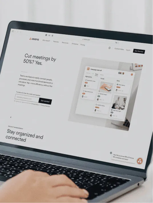 A product designer reviewing a SaaS user interface on a laptop, identifying common UX design mistakes including poor onboarding, cluttered features, and lack of user research during the design process.