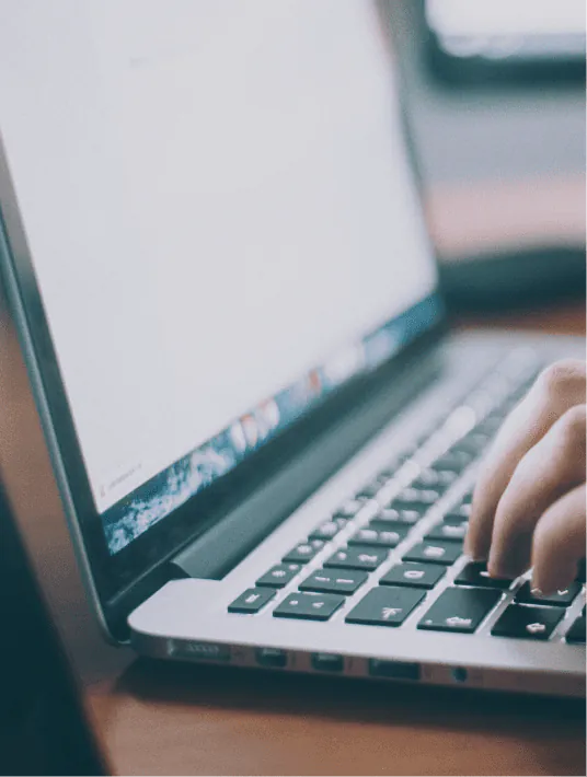 Developer and UX designer reviewing a government website interface on a desktop screen, focusing on accessibility features, navigation structure, and mobile responsiveness