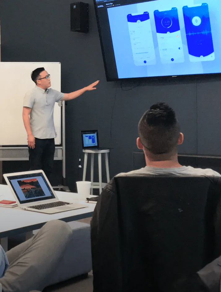 Enterprise UX designers collaborating on dashboard wireframes, workflow mapping, and data-driven software interfaces for business applications.