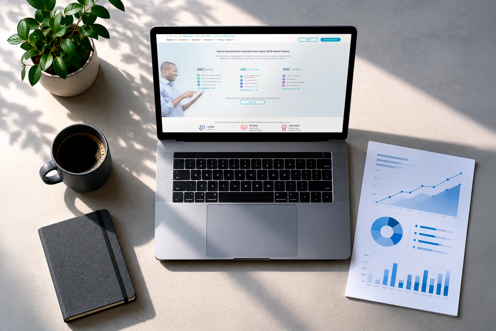 Laptop with a SaaS website on screen next to an analytics report showing upward conversion trends, representing measurable results from strategic website design