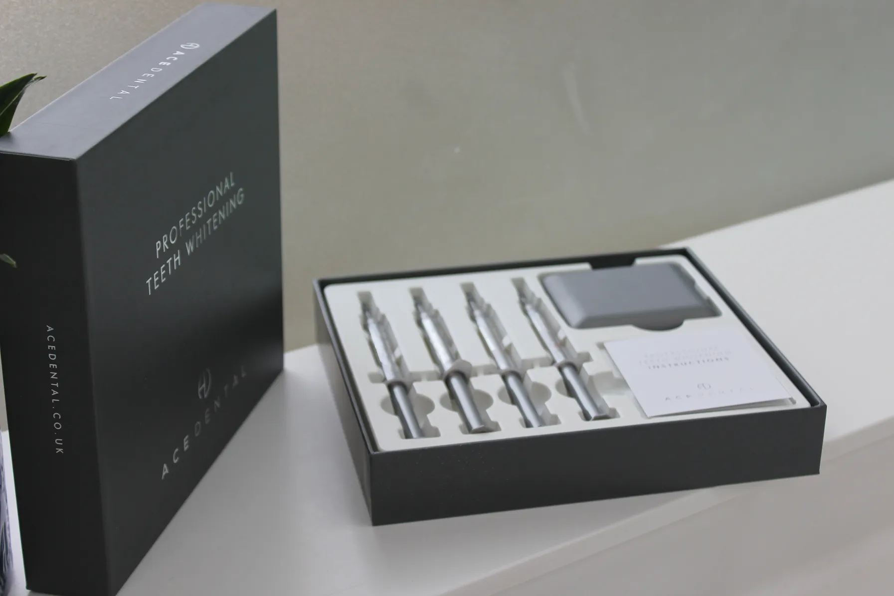 Open professional teeth whitening kit with four syringes, a case, and instruction leaflet on a white surface.