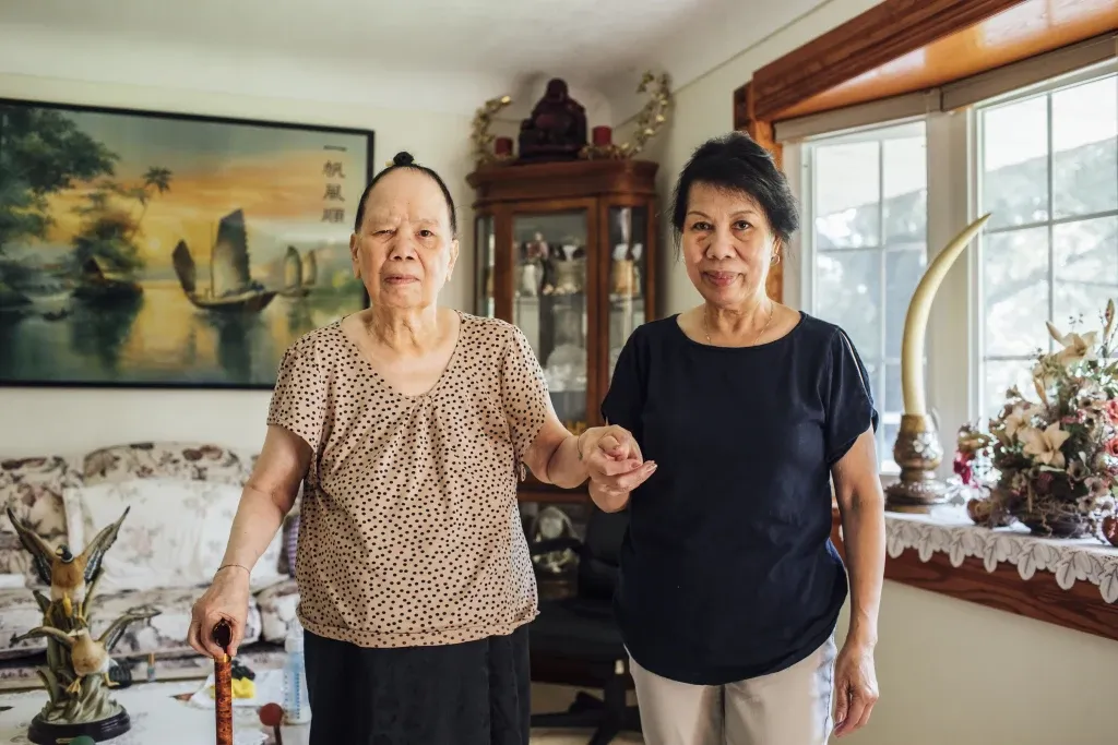 Caregiver providing culturally-sensitive home care for a senior.