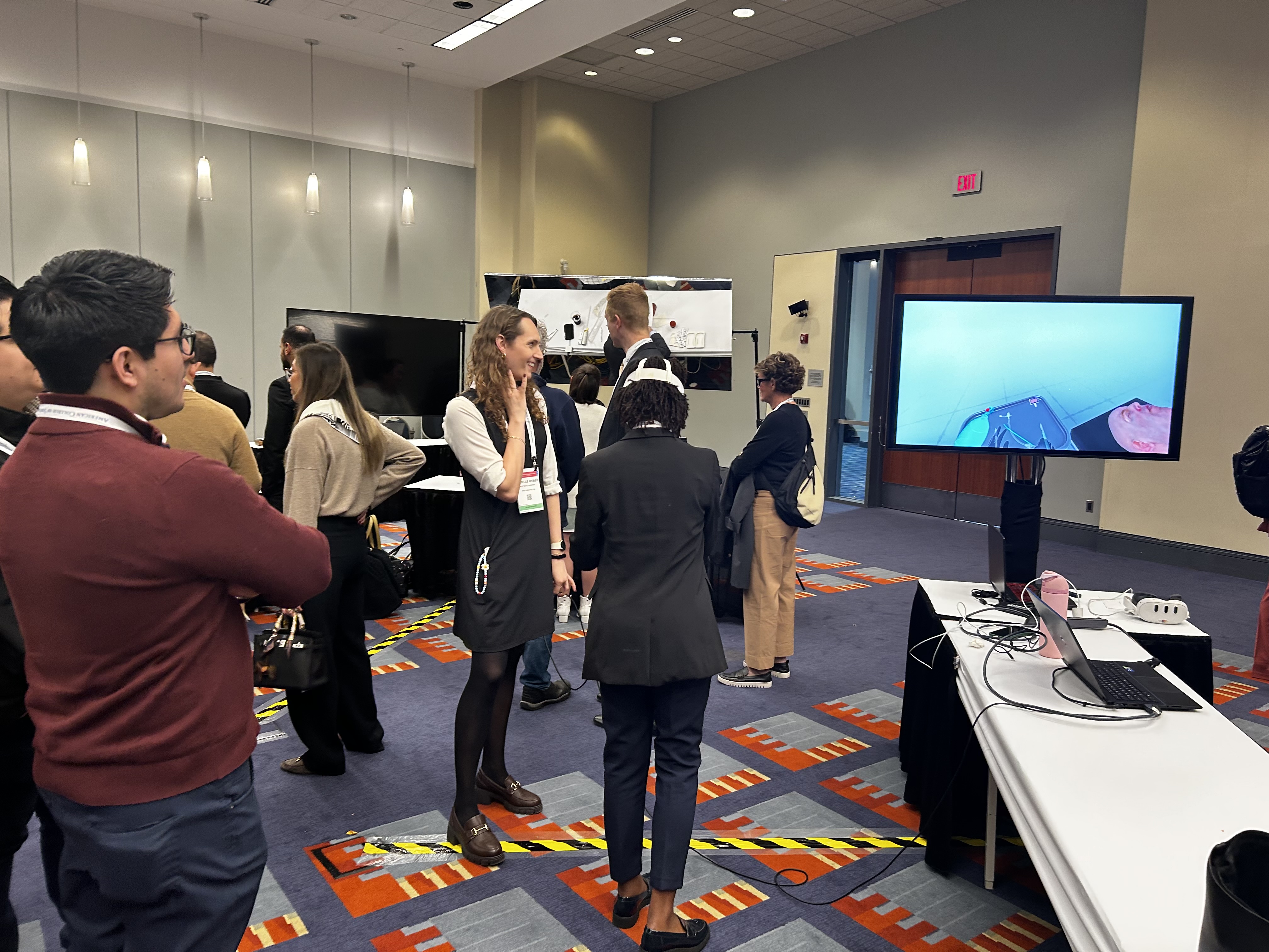Attendees gathered around a virtual reality surgical training demonstration at ACS Clinical Congress 2026