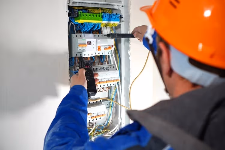 Electrician testing a residential circuit breaker.