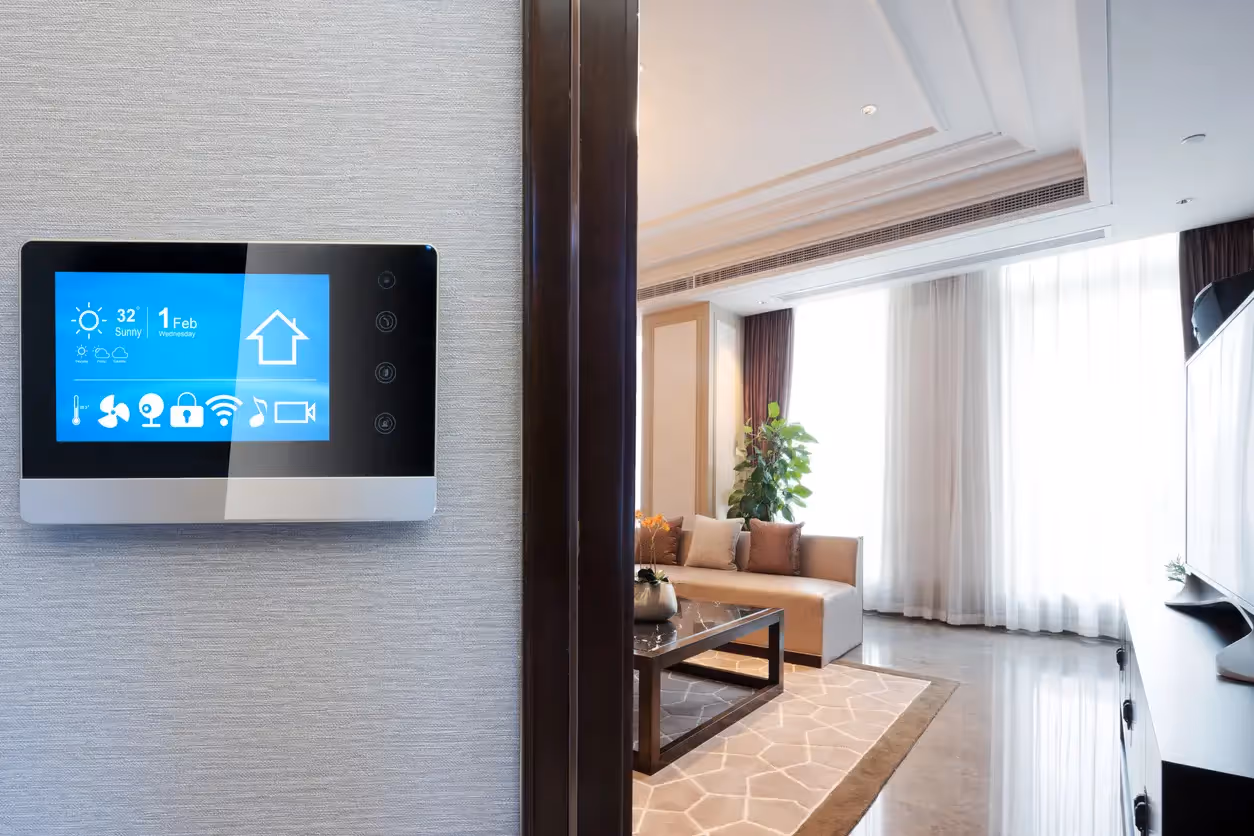 Wall-mounted smart home control panel displaying security, climate, and lighting icons.