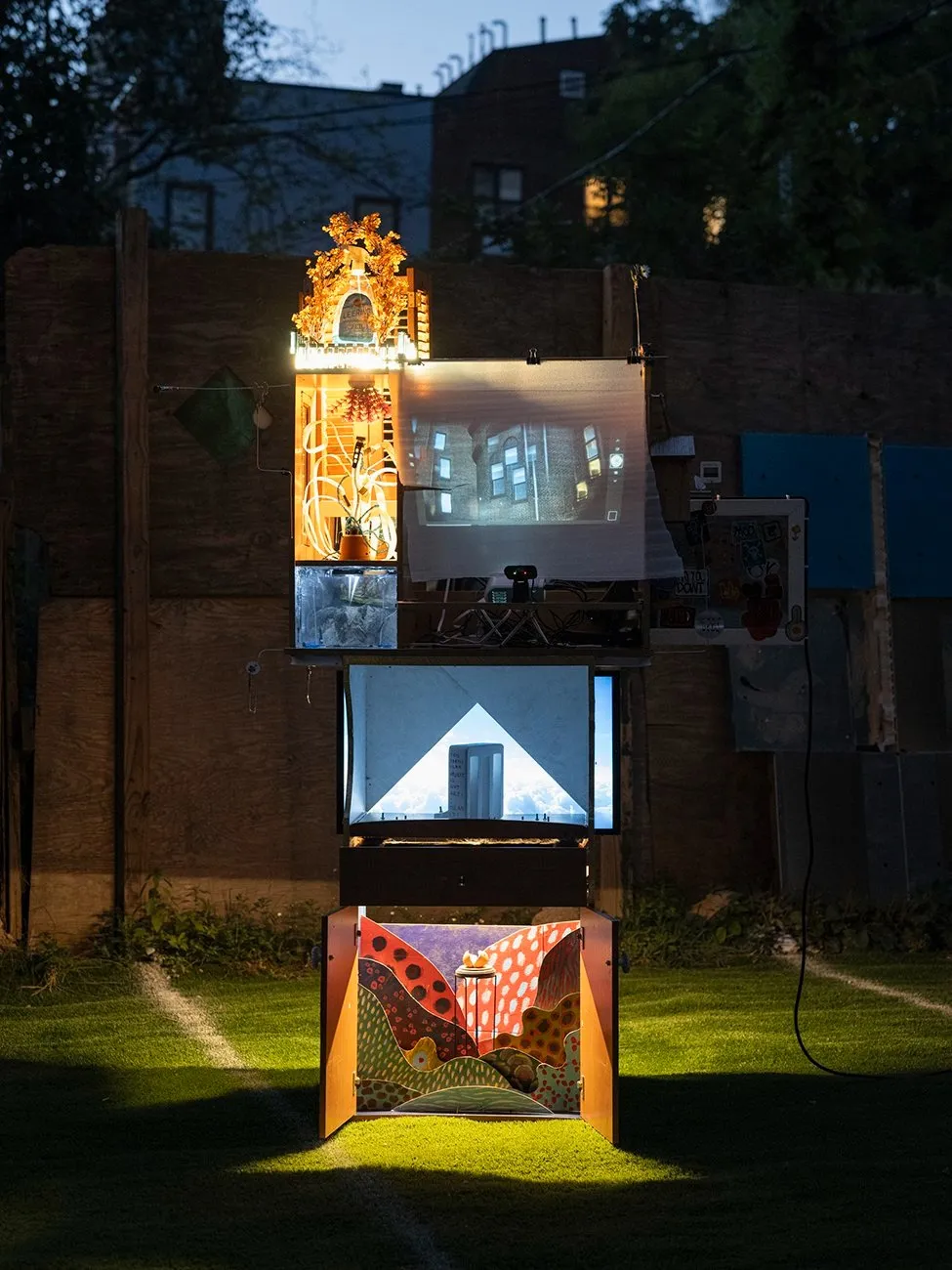 Three story house-like installation in park at night, artificial mountain and sky views, Petros Lales, The Mysterious Disappearance of the Lost Eggman, interactive multimedia installation.