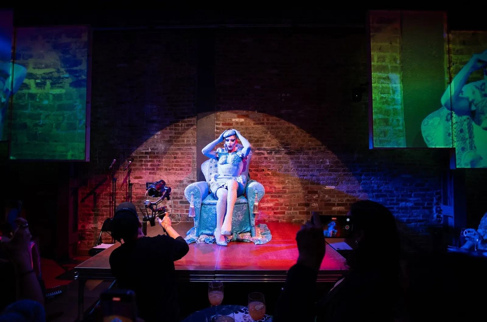 Drag artist performer Sasha Velour dressed up as blue honorary chair at La MaMa theater's 63rd benefit party, in a room full of partygoers, the big reveal live show.