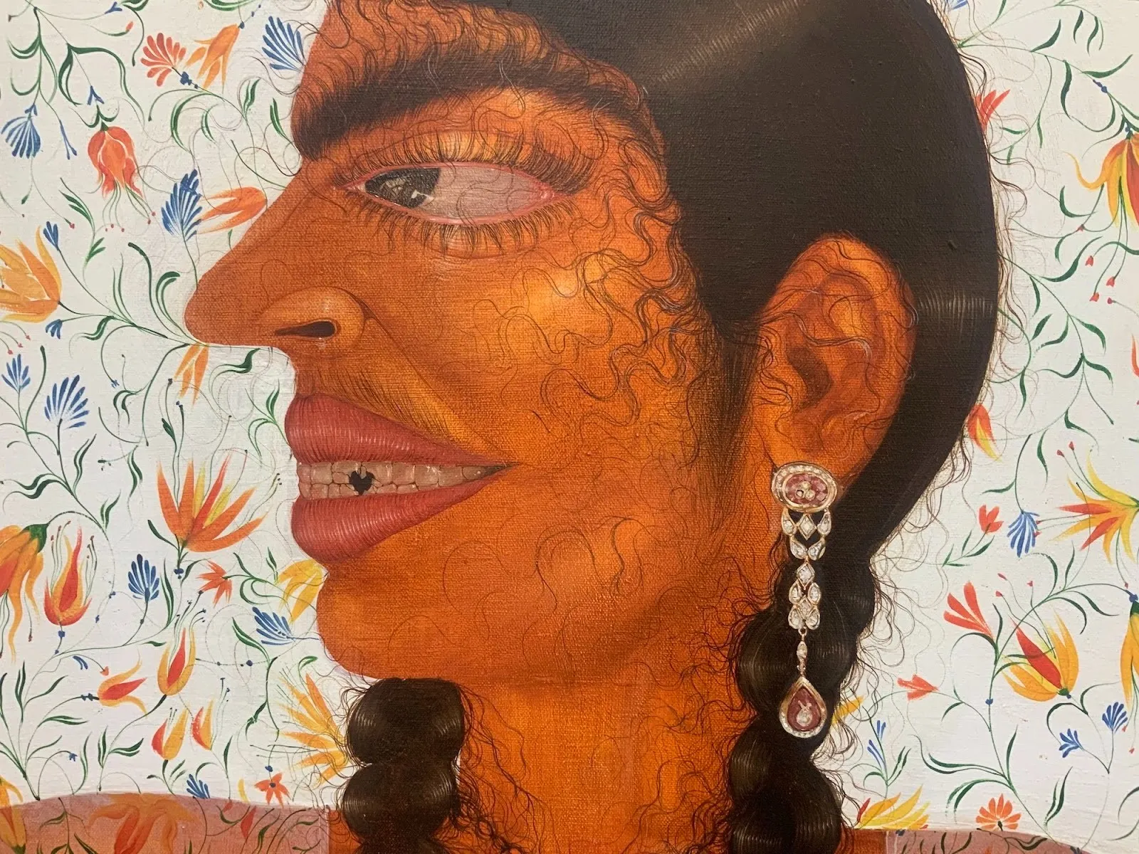 Oil painting of Indian woman side profile wearing ornate earring and hair braids, thick brows and prominent nose are emphasized, set against floral wallpaper background, Paree Rohera diptych to love to lose figurative art.