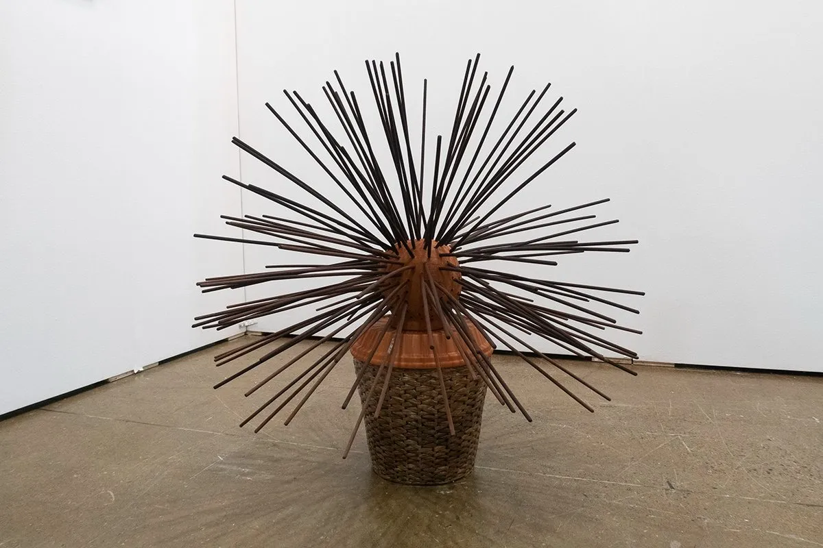 Lamar Robillard, Holding Space, ceramic sculpture with incense sticks forming a concentric circle sticking out of its body, installation view of art toronto, BAND gallery.