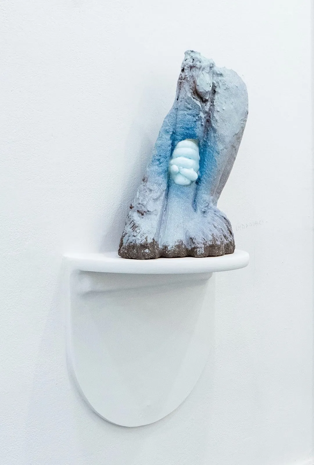 Blue clay and ceramics sculpture was a piece of round bug like protrusion, Lydia Nobles, Freeze Thrust, 2024, on view at Pratt’s Steuben Gallery, art about Reproductive Rights, sexuality and gender.