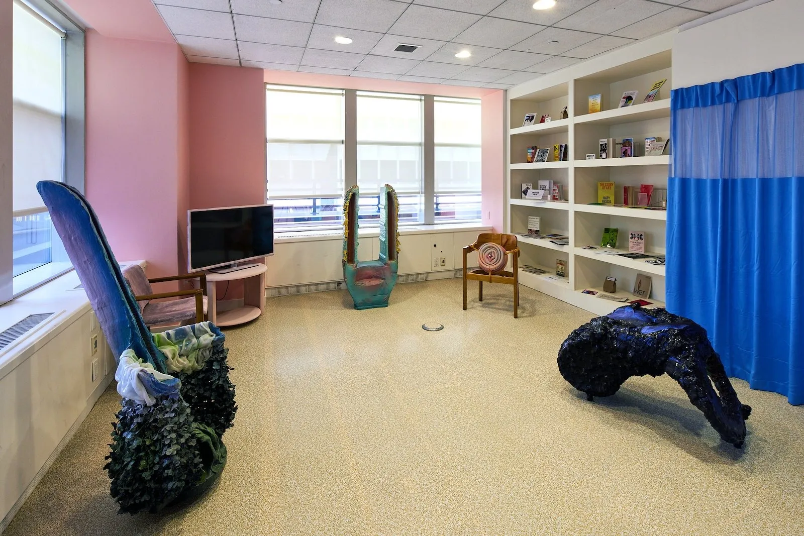 Installation view of in the waiting room, multimedia sculpture by artist Lydia Nobles addressing art, activism body autonomy, and Reproductive Rights, KAPOW booth spring break art fair, Samuel morgan photographer, pin k pastel background.