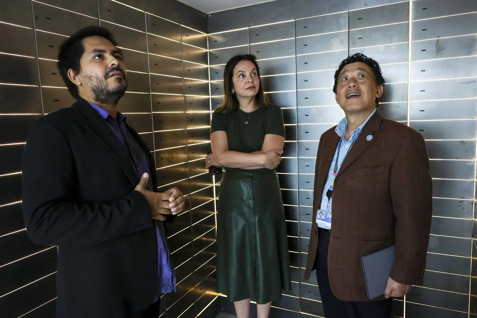 From the left, Lucas Memmola, artist, Carla Barroso Carneiro, Brazil ambassador and permanent representative to FAO, QU Dongyu, FAO director-general, visiting the vault of Paradise Bank, Rome, 2024.
