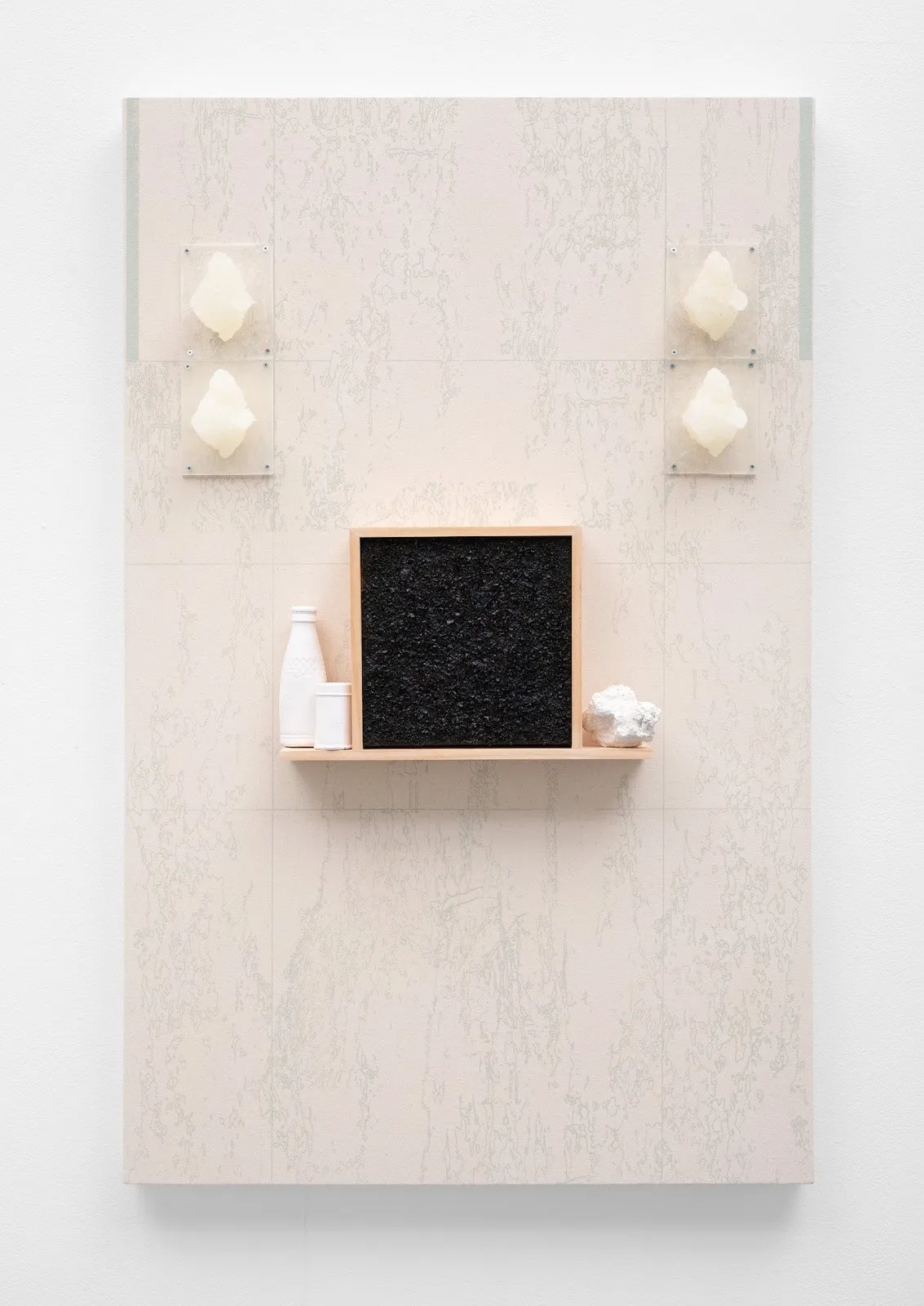 Mineral blocks, a sheet of seaweed, and porcelain vessels adn bottles on a shelf against pale pink background with landscape drawings, transducer (kotsuage) by naomi nakazado at spirit duplicator Olympia gallery.