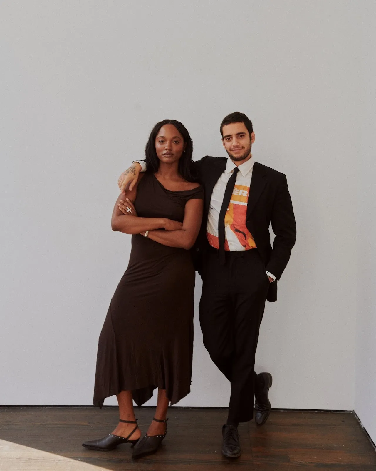 Curators Gabrielle Richardson and Saam Niami standing next to each other confidently against gallery wall, 25 allen street new york now anthony hilliard, impulse magazine, reported by sophie steinberg.