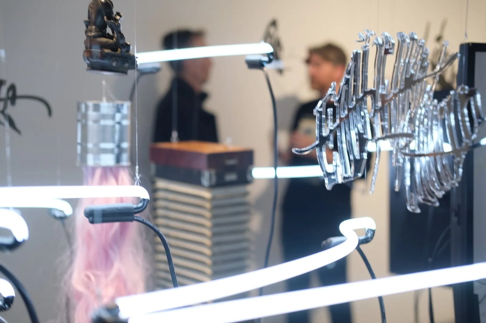 Digital avatars of artist shown on computer screen with wires connecting memento mori and neon lights, installation view of Frank WANG Yefeng, Avatopology at NARS Foundation, curated by Natasha Chuk.