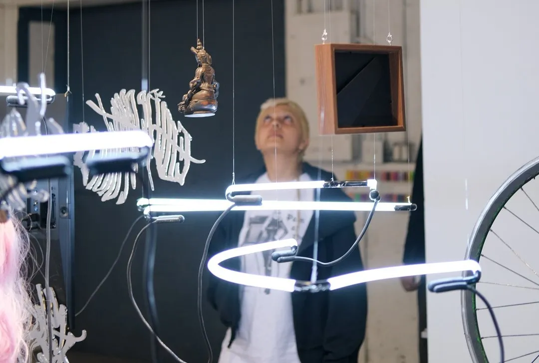 Digital avatars of artist shown on computer screen with wires connecting memento mori and neon lights, installation view of Frank WANG Yefeng, Avatopology at NARS Foundation, curated by Natasha Chuk.