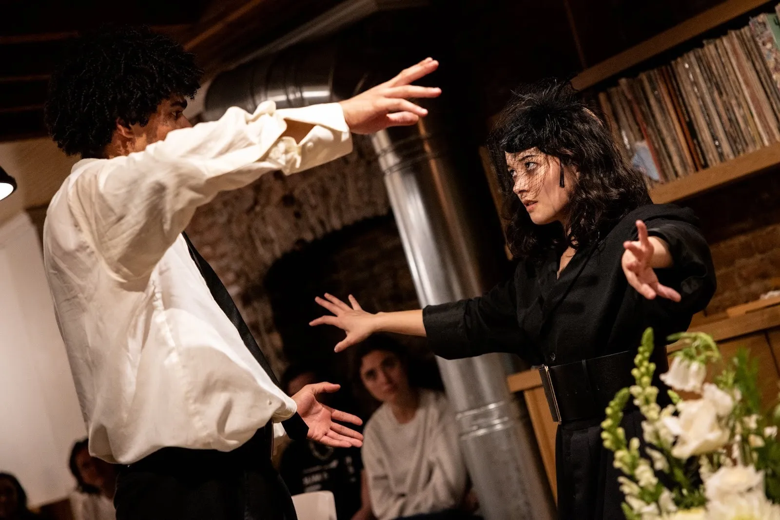 Two actors with arms open confronting each other fiercely, jonah o'hara-david and izabel mar in family off broadway theater by celine song, directed by alec duffy, hoi polloi, kinship and monstrosity.