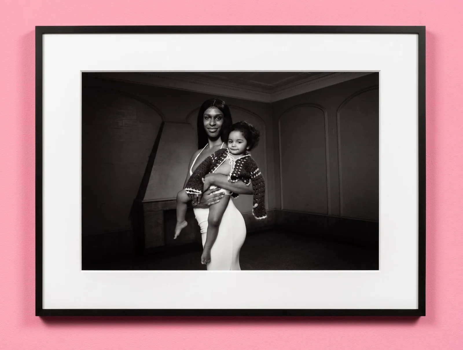 Jan Antonio Diaz, Mother and Son, black and white photograph of queer transgender mother holding a baby in dark nursing room, feminine subjectivity and Camp group exhibition, Bad Girls, OCD Chinatown.