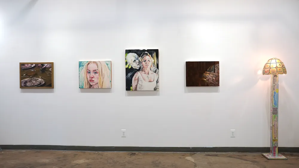 Four oil paintings installed on White Gallery wall next to floor lamp sculpture, pop culture and self-perception in group exhibition obsessed at zepster gallery.