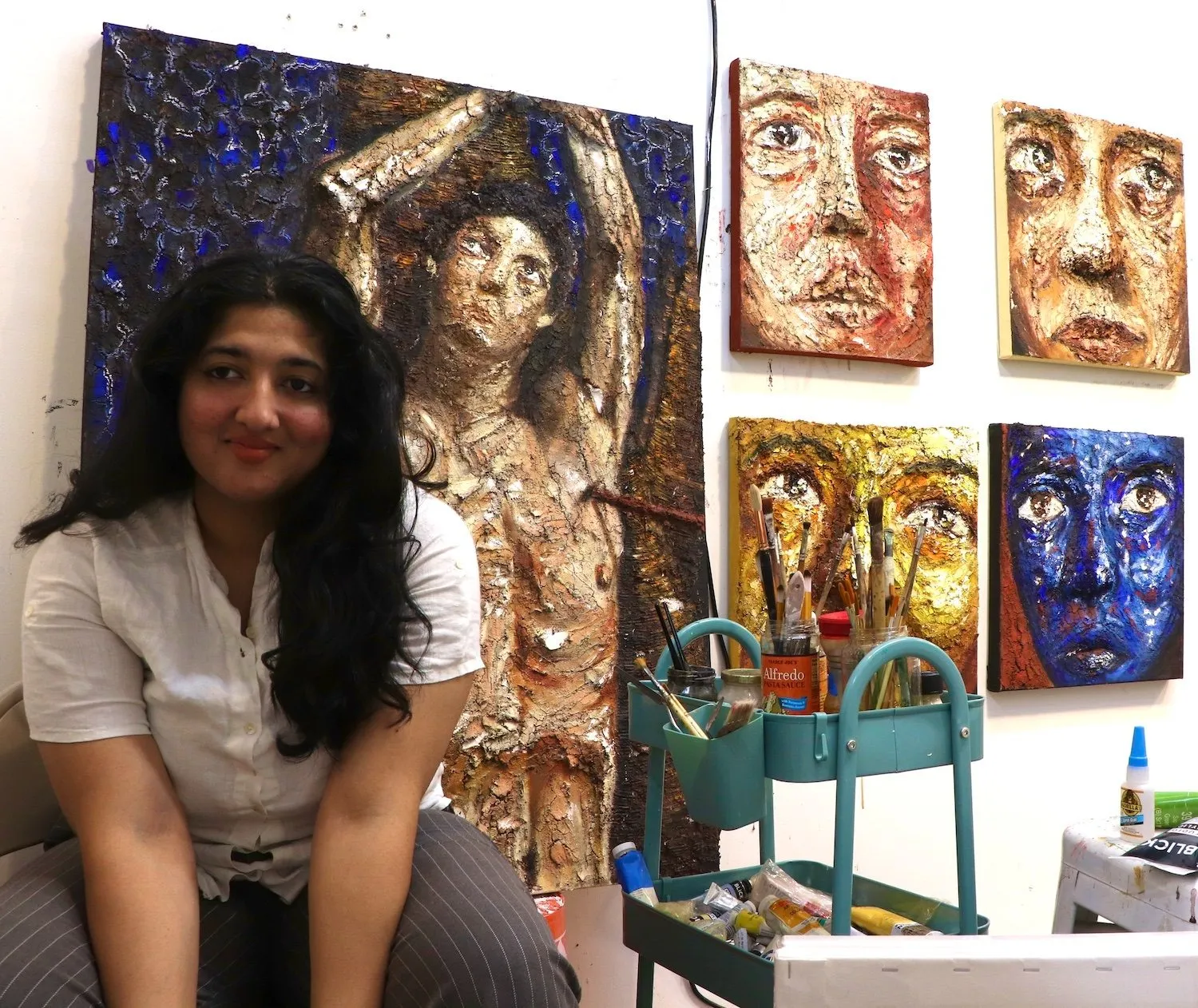Studio portrait of Anoushka Bhalla, International Indian artists based in New York, creates works in oil terracotta, and PVA, addresses post-colonial archives and history.