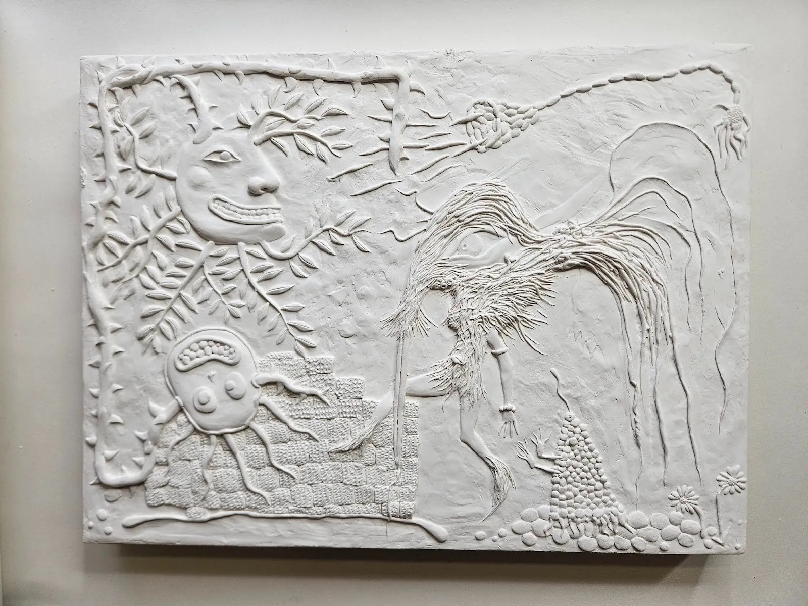 White monochrome relief sculpture of monstrous creatures and plants, tim noble, happy land, solo exhibition palo gallery.
