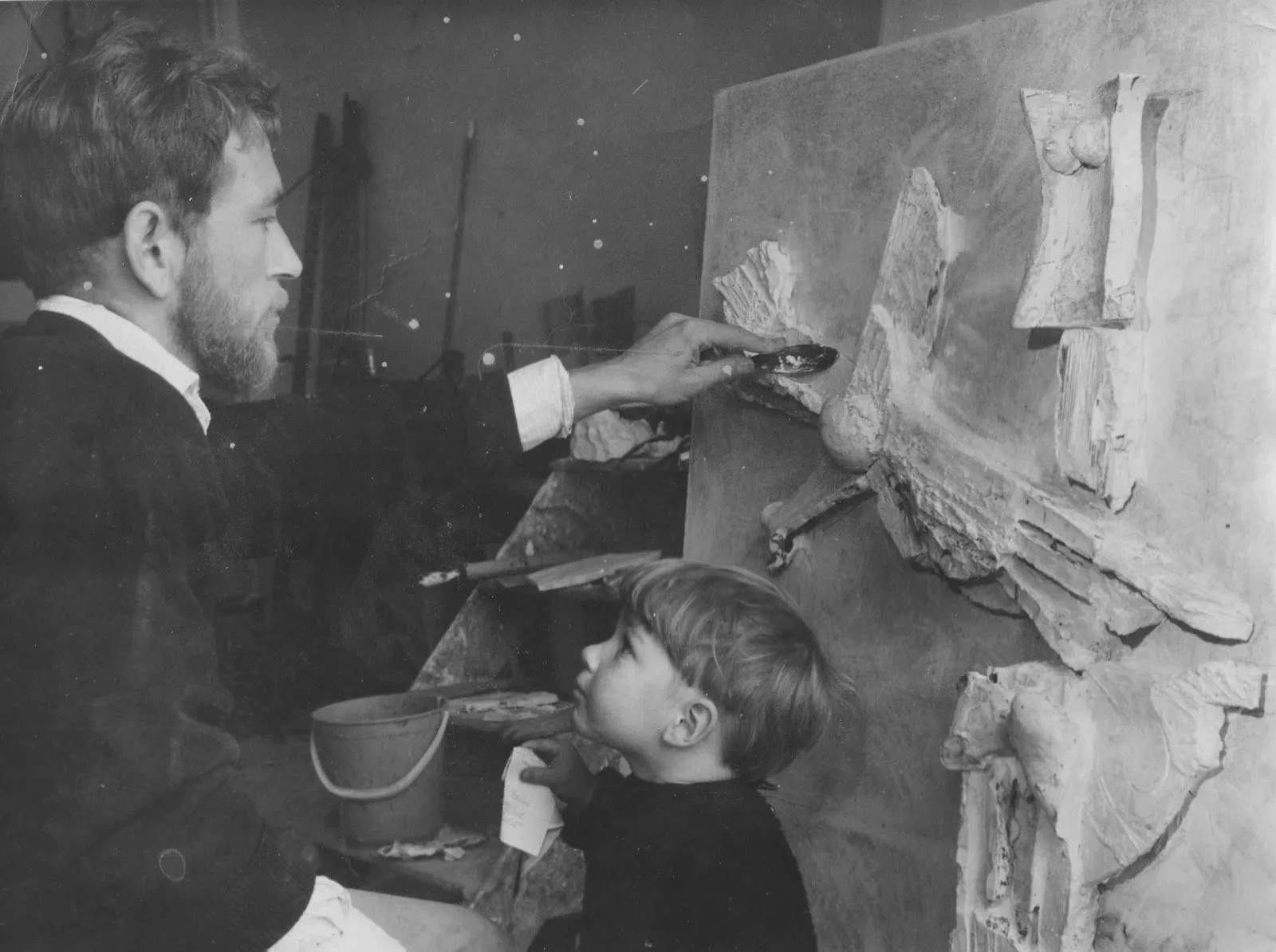 Black and white photograph of young tim noble next to his artist father sculpting at the easel, happy land, solo exhibition at palo gallery archive.