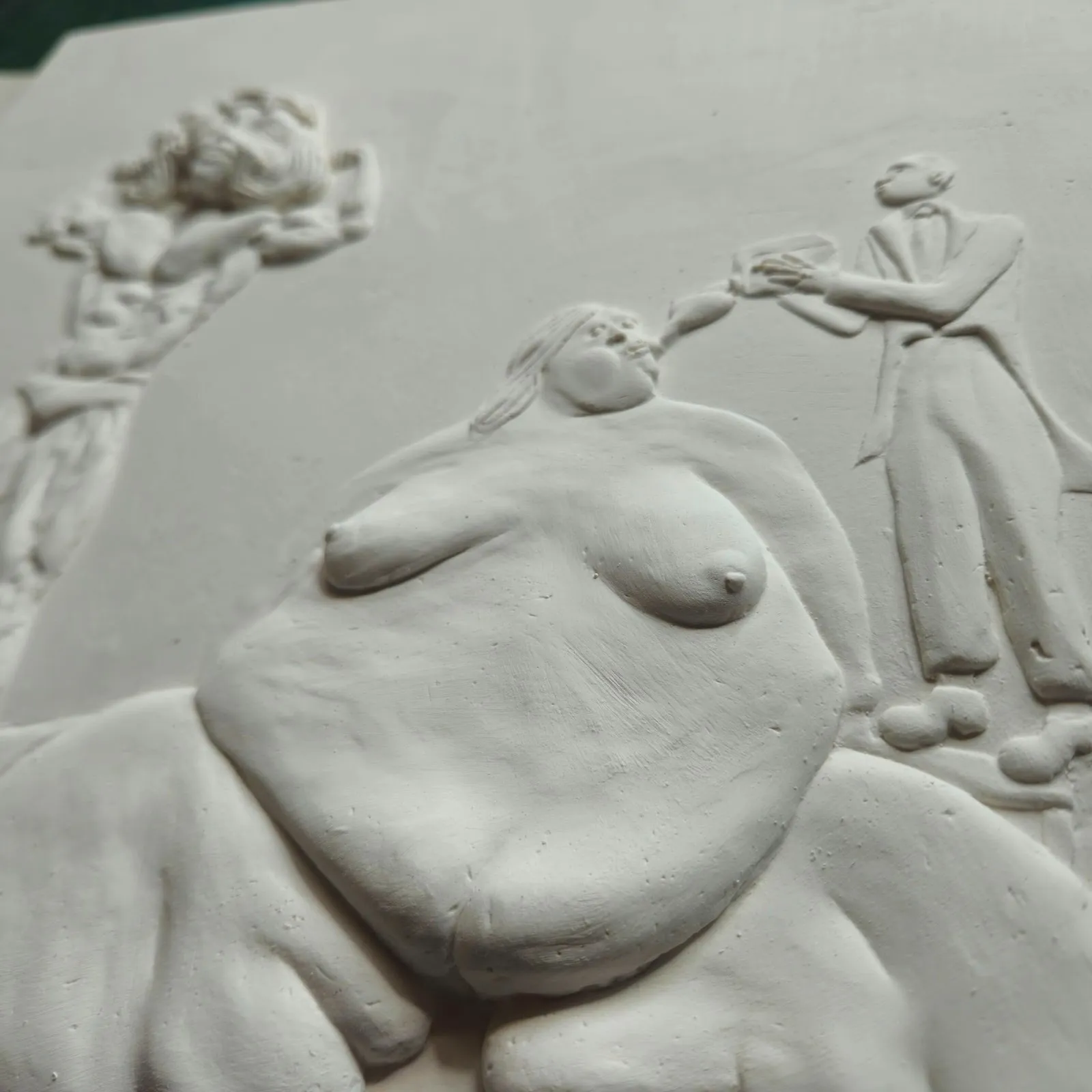 White monochrome relief sculpture in jesomite by british artist tim noble, naked women fed by man, palo gallery solo exhibition happy land.