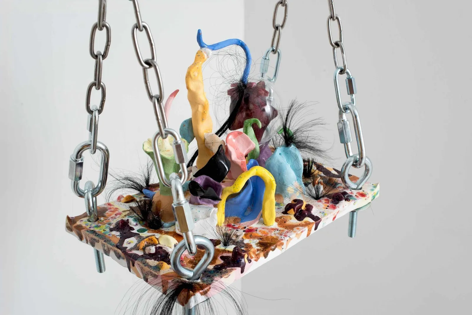 Lulu Luyao Chang, detail of The Red Star is Rising (2024), colorful glazed earthenware sculpture with synthetic hair and steel chains, little knots in my hair gallery 456.