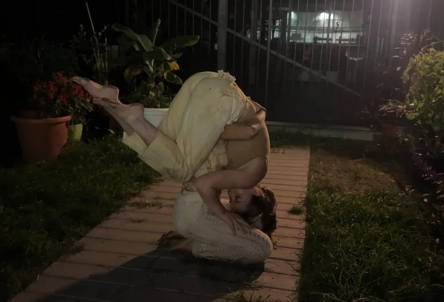 Two dancers acrobatically on top of each other in white, frank white memorial garden, garden of voices embodied earth and project iii, interview with nicole jackson and kasey broekema.