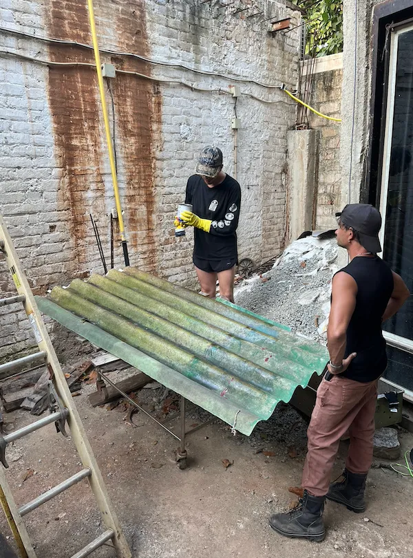 Filippo Vogliazzo working during the second run of Casa Caché Artist Residency, birds-eye view of berlin-based italian conceptual artist painting lamps.