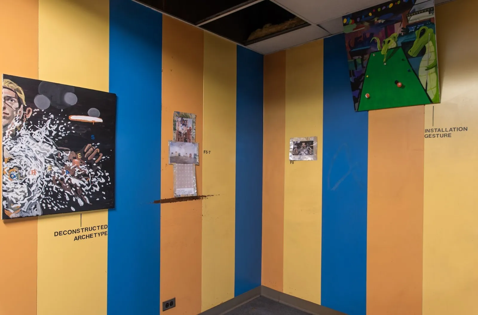 Installation view of an image of your labor hovers over me, new uncanny gallery group exhibition curated by qingyuan deng, pop realist paintings installed on walls with yellow, orange, and blue stripes, gunner dongieux.