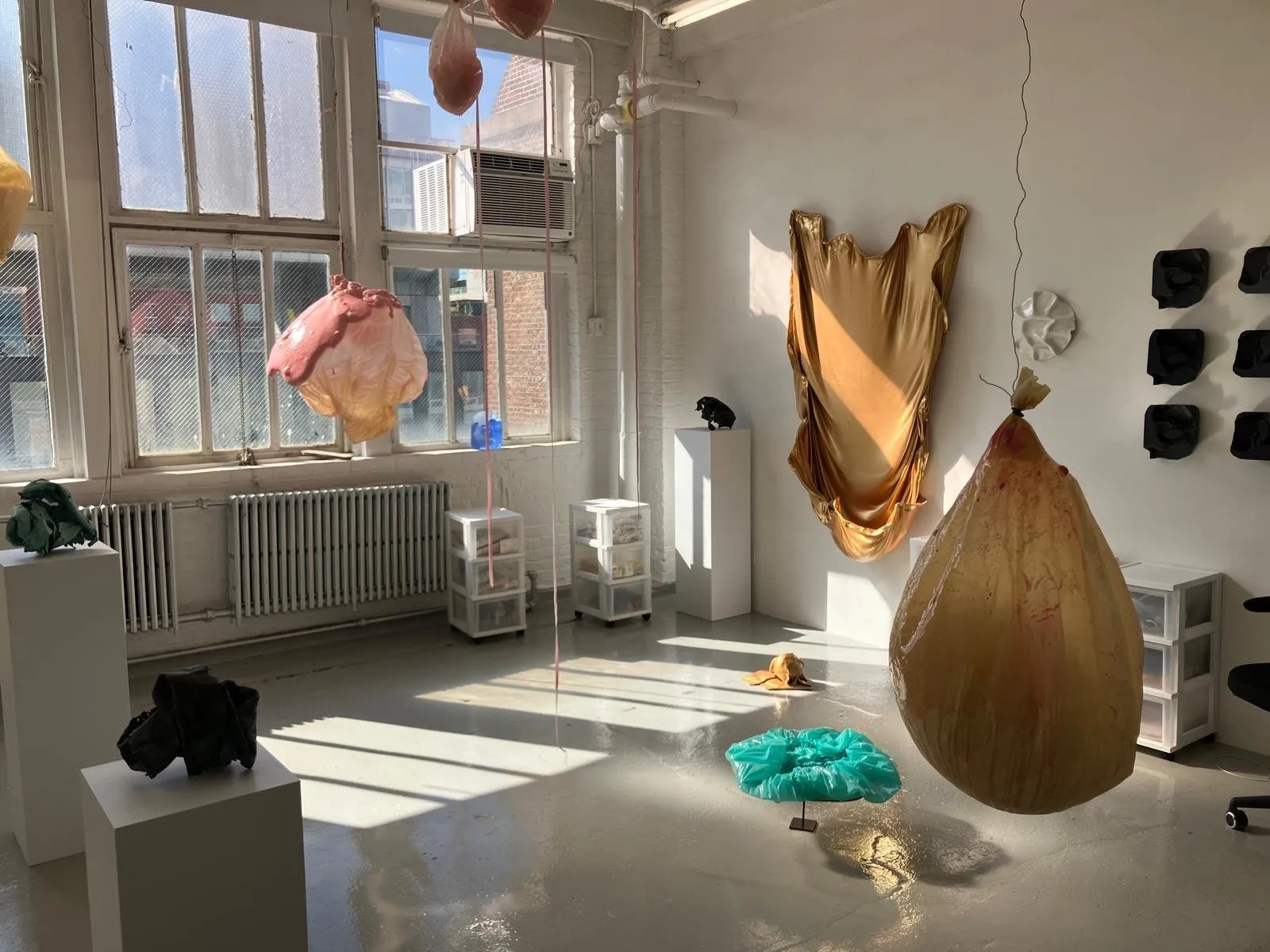 Studio of Sculpture artist Lesley Bodzy in chelsea new york, with gold paint skin, deflated balloons, and 3d printed sculptures, interview with journalist xuezhu jenny wang.