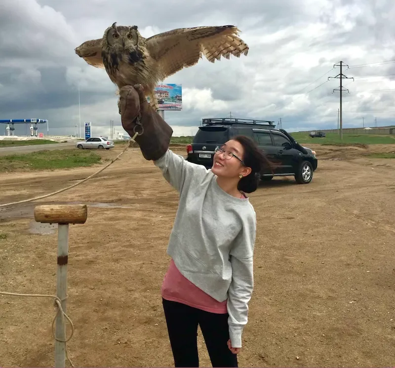 Michi Zaya, Mongolian theatre director, actor, designer, producer, and creative technologist, storyteller immigration interview old photo with eagle