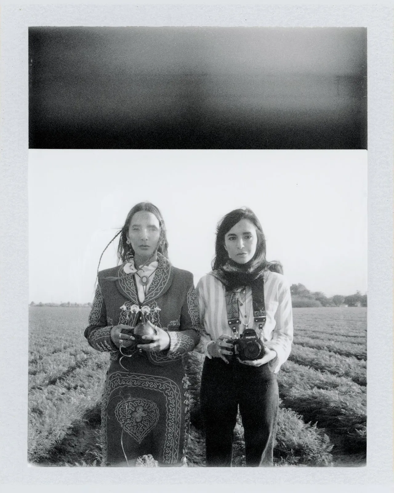 Black and white analog photos of twin sister Amber Maalouf and Ashlie Chavez standing in onion field with camera wearing Chihuahuan clothes.