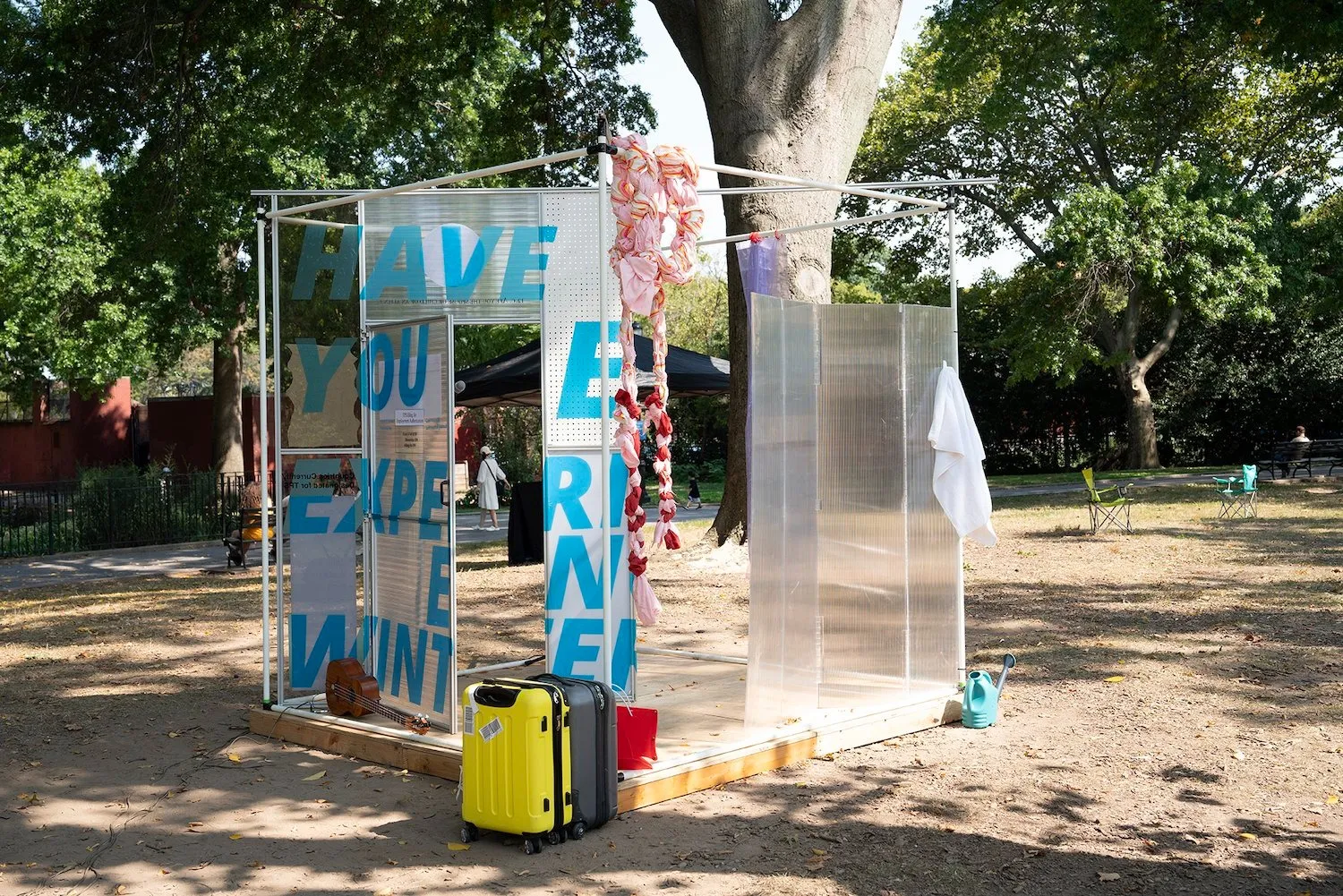 Suitcases and printed mesh installation about immigration policies Xenoduo. A Mobile Home. Public installation at Sunset Park, More Art.