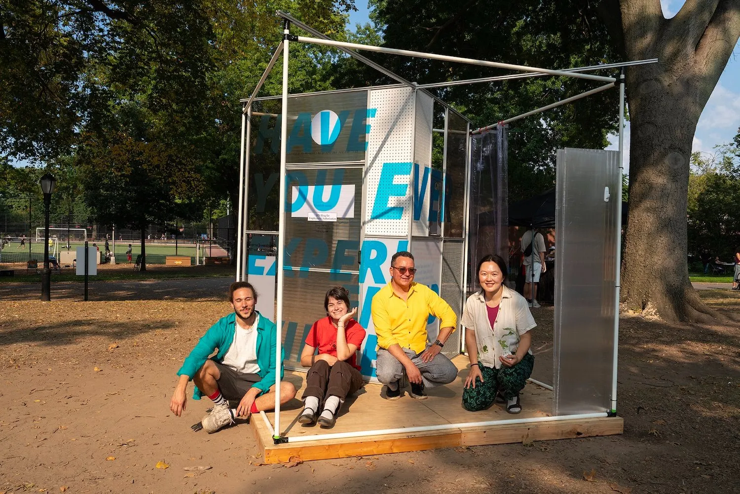 Four artists in front of immigration TPS public art installation in Sunset Park Xenoduo.