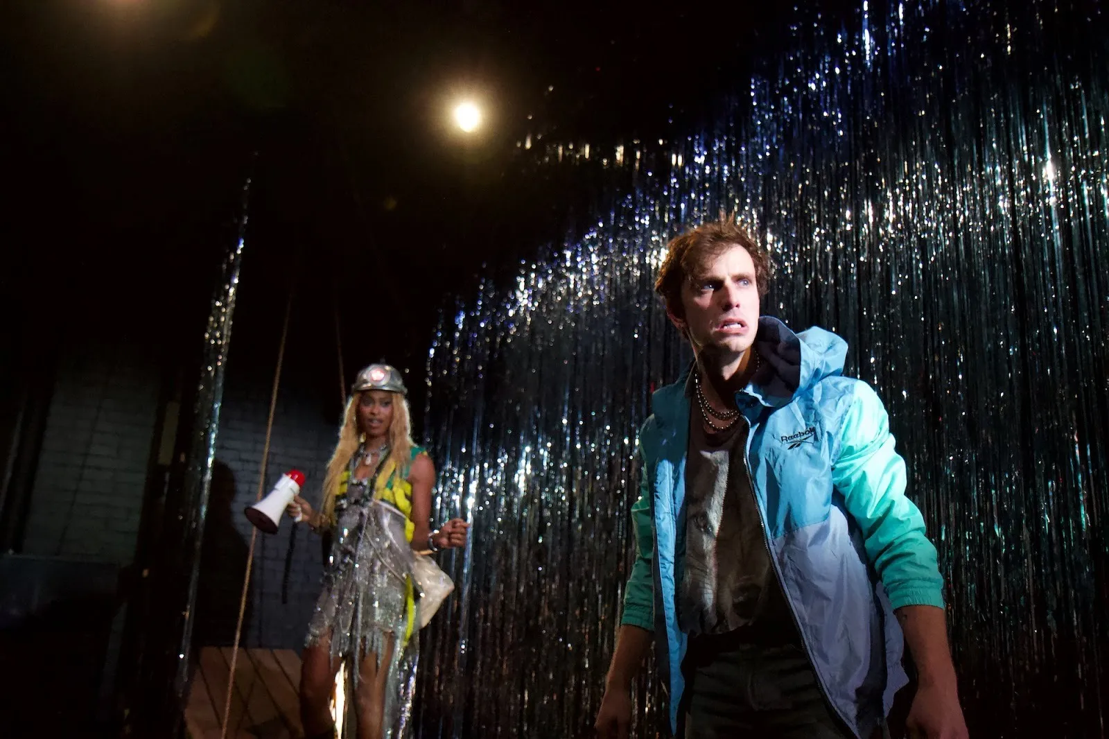 Mariyea Jackson and Max Kantor looking concerned about end of the world in front of silver background, isle vile at the tank.