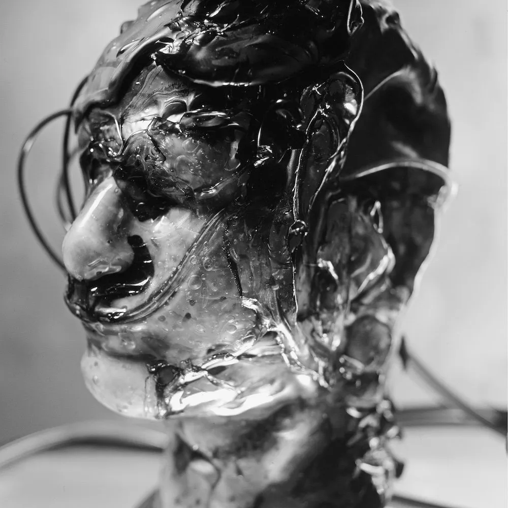 Black-and-white photograph of mannequin covered in  polymerized PVA glue, PVC, styrofoam, dystopian and posthuman photography by Terrance James Jr. at GHOSTMACHINE.