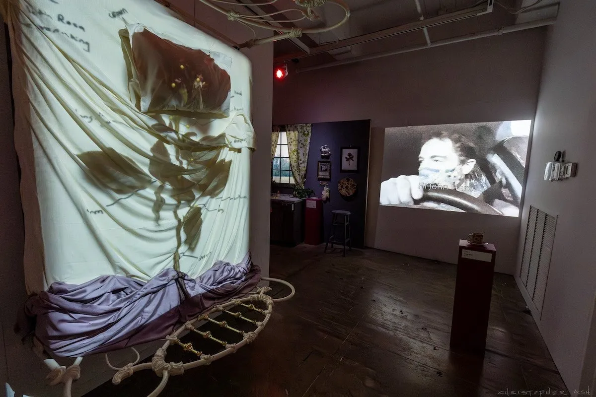 Immersive exhibition gallery room with two film projection, rose and helix installation, white curtain screen at John Jarboe's gender journey, the rose garden, at fabric workshop and museum Philadelphia.