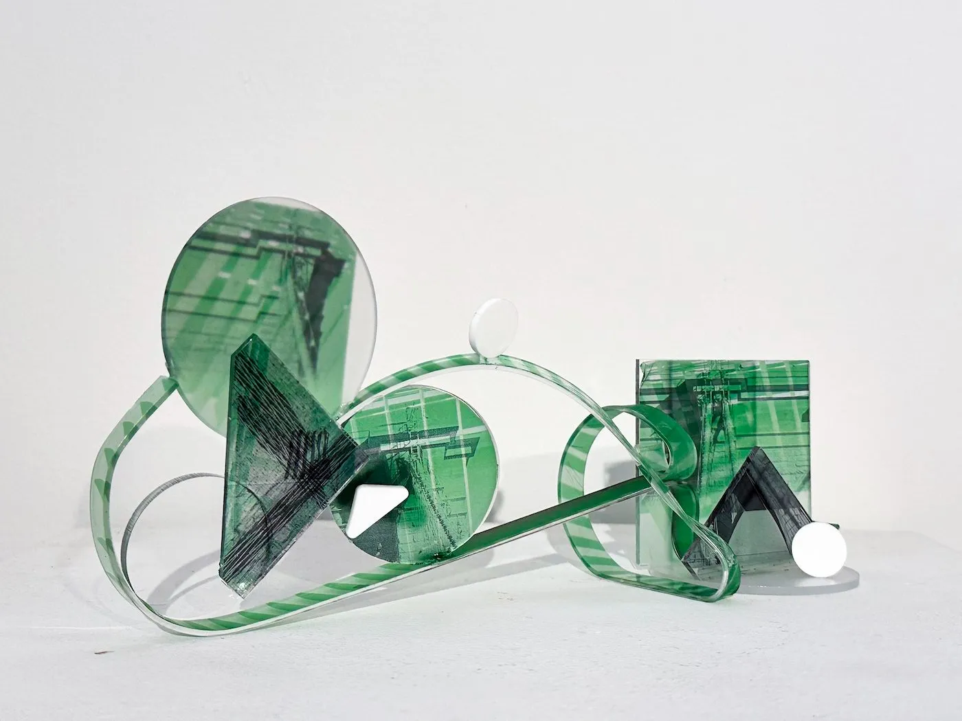 Green acrylic printed with architectural details cut into circles triangles and stripes, Jingyao Huang, Study of the Bridge #2, photographic sculpture.