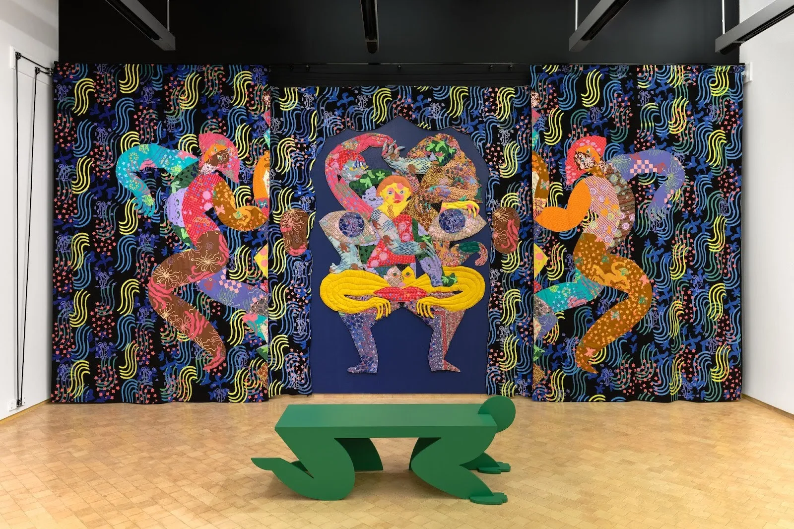 Maria A Guzman Capron, En Tu Mirada (In Your Eyes), installation with colorful textiles and a green bench as if someone kneeling over, el museo del barrio flow states review by sterling corum, contemporary Latinx group exhibition.