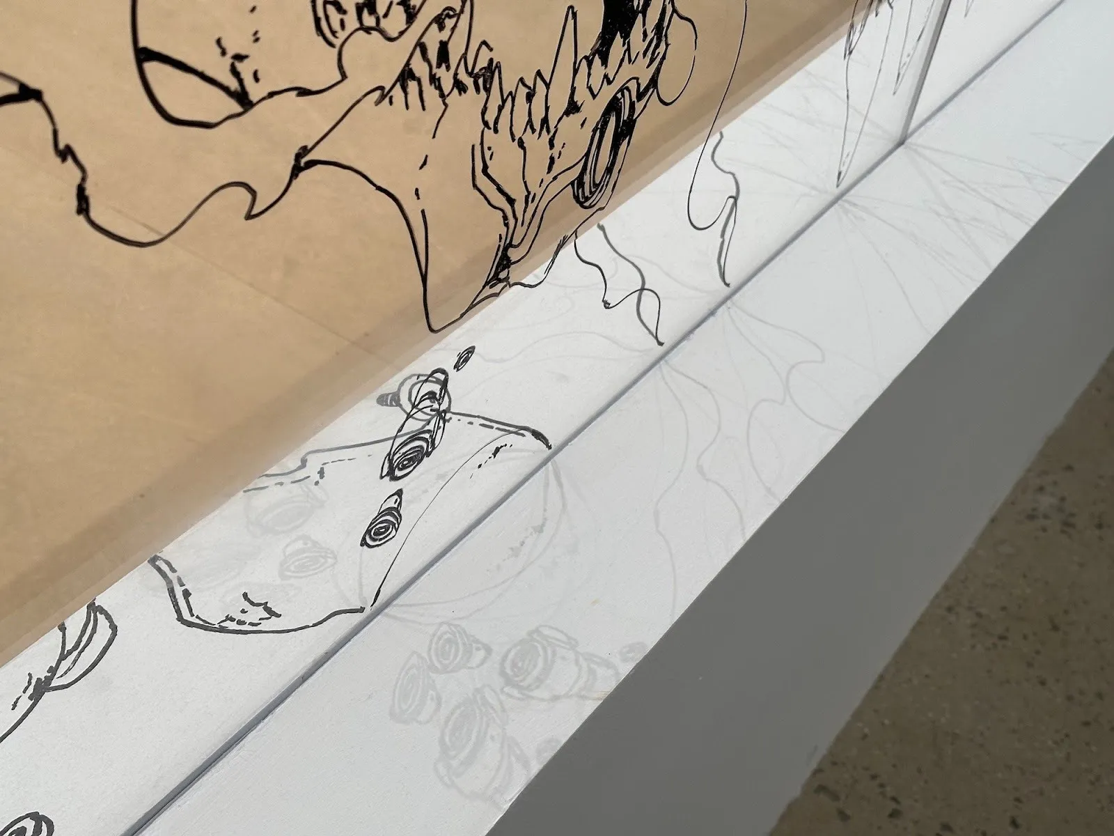 Acky Bright japanese artist solo exhibition studio infinity at japan society, installation view, reviewed by a.e. chapman, wall and glass with anime and manga style black and white drawings.