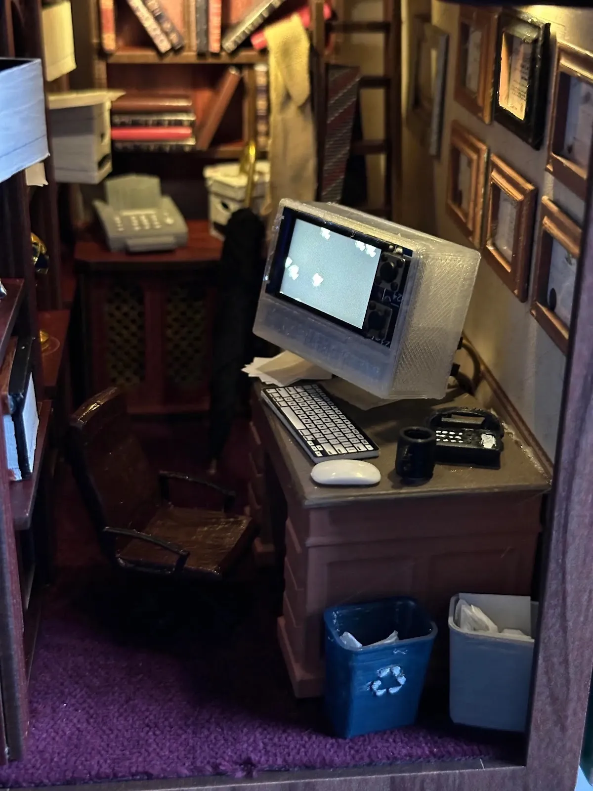 Miniature of a small office, wooden desk and chair with computer monitor and recycling bins, suite 2412 installation by Josh Sucher, the Brooklyn artists exhibition, impulse magazine review.