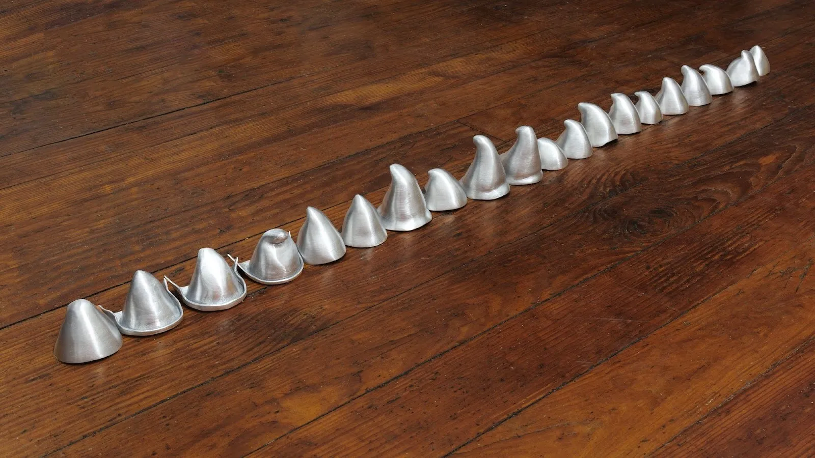 Row of 20 hats printed in 3D aluminum alloy, each referencing an individual Animal Friend of Cinderella's, reference to Disney Cinderella 1950, solo exhibition, goes around in circles til very very dizzy, YveYANG Gallery.