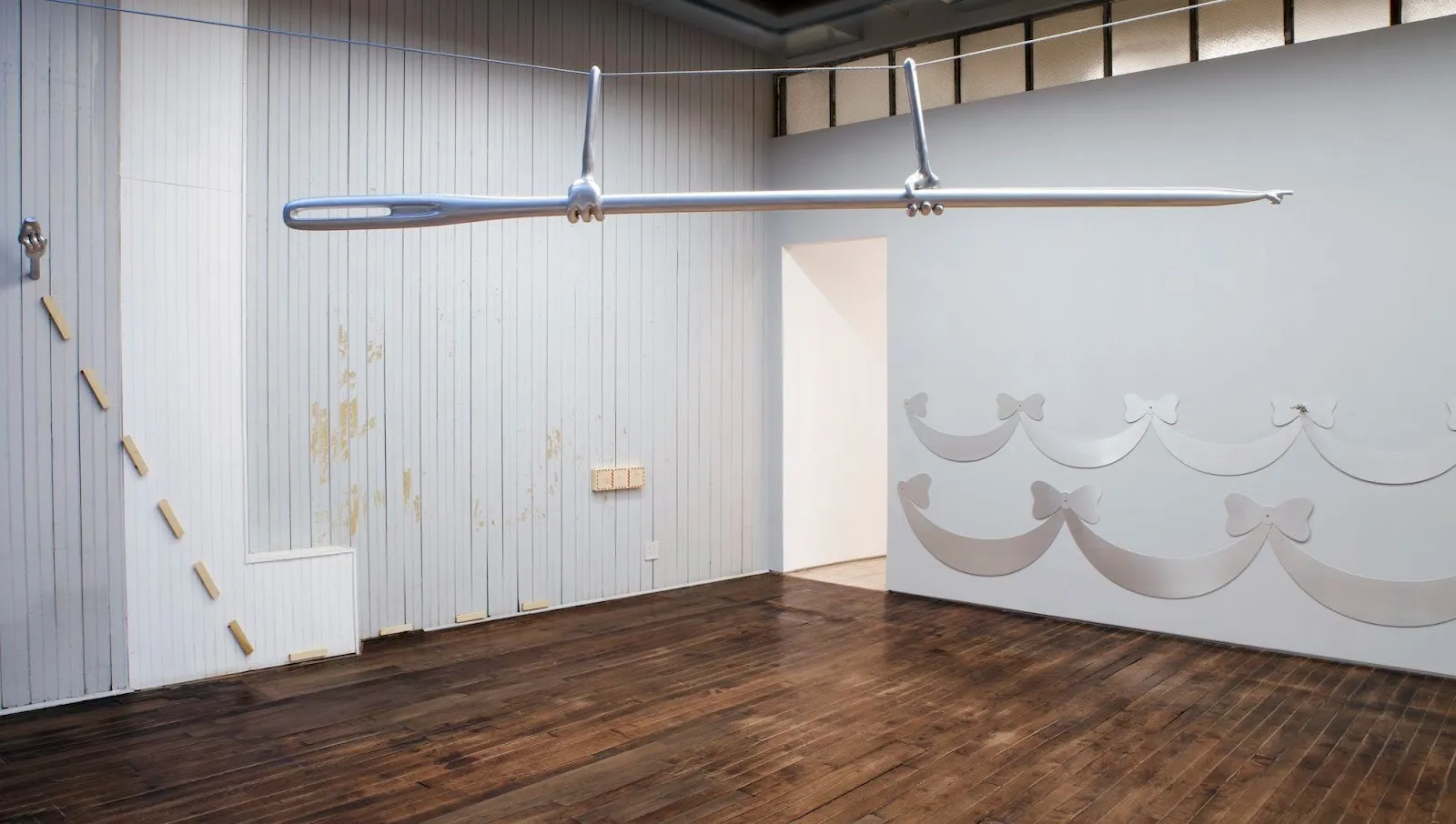 Suspended needle hand sculpture hovering over Gallery floor, 3D printed aluminum alloy on the wall mimicking dress trims, , reference to Disney Cinderella 1950, solo exhibition, goes around in circles til very very dizzy, YveYANG Gallery Huidi xiang.