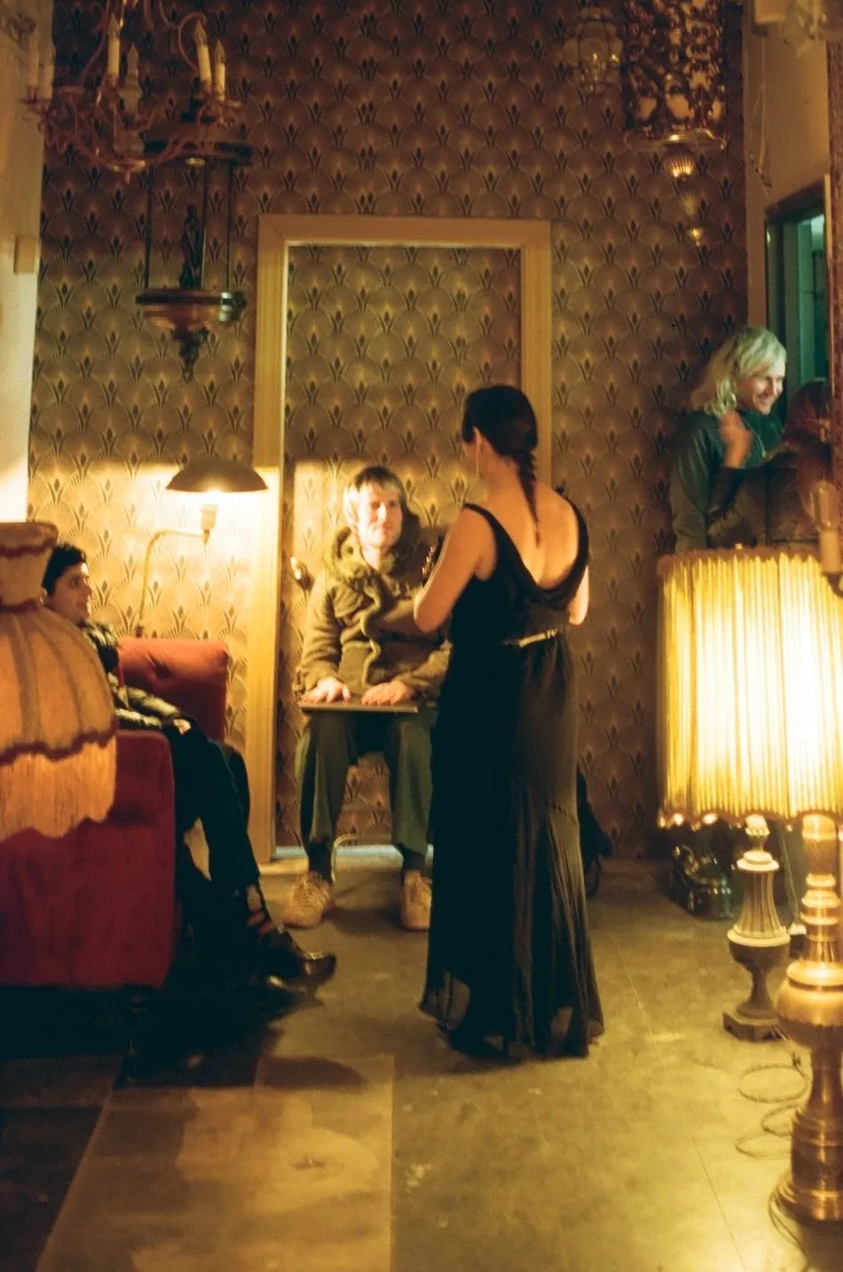 Four people talking and vintage inspired Bushwick church basement, Hollywood Revival style interior with red couch, photographer Nick Brito, performance nonprofit Project iii, stamina dance techno party.