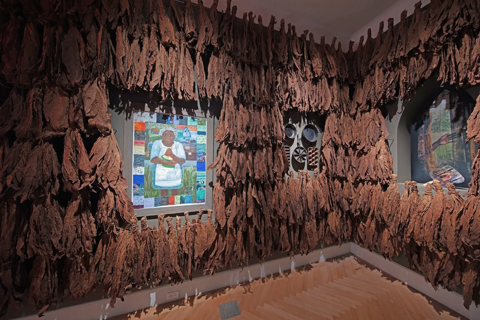 Room installed with dried tobacco leaves and paintings, so that you all won't forget speculations on a Black home in Virginia, curry hackett, smithsonian design triennial making home reviewed by sterling corum.